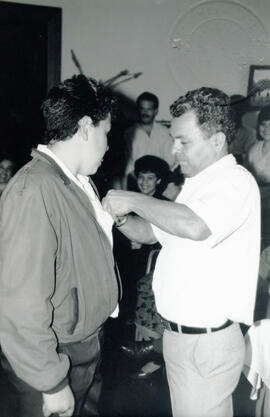 Fotografía de José Àngel Alfaro Cerdas, Jefe de la Sección de Conserjería colocando un gafete a u...