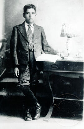 Fotografía de un muchacho de la época principios de Siglo XX. Se observa la vestimenta: vestido e...